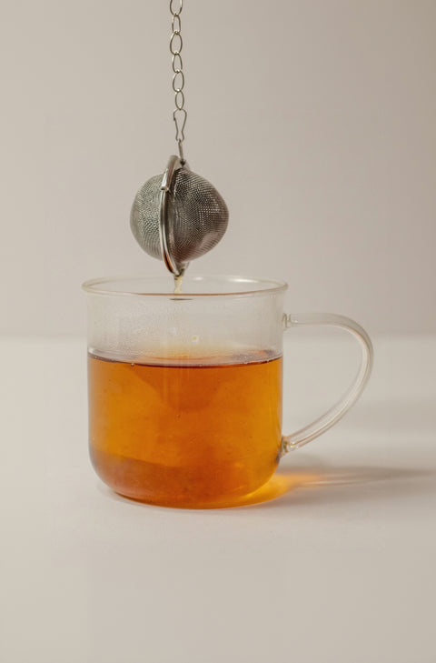 Tea Ball Steeping with glass cup full of tea
